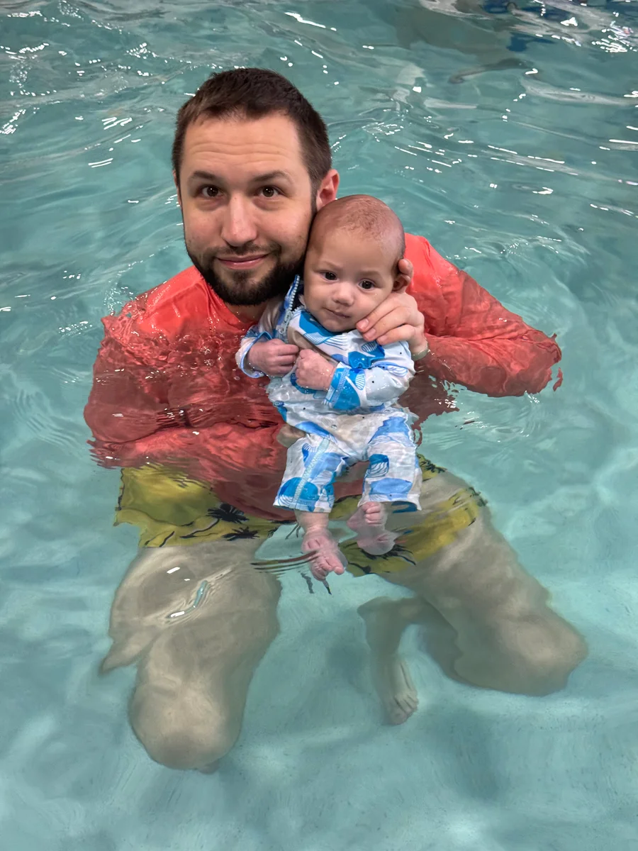 Phil holding Ethan during their swimming pool time